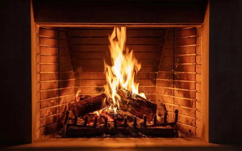 Fig & Ember — flames in the wood-fired kitchen